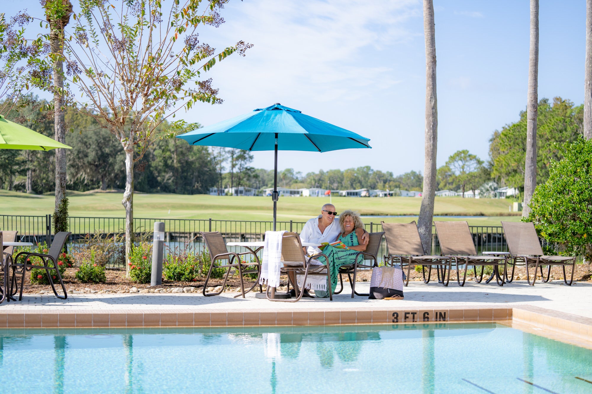 Couple Relaxing by Pool - Cypress Lakes Village