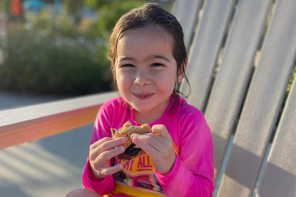 little girl eating s'mores at Creekfire Resort