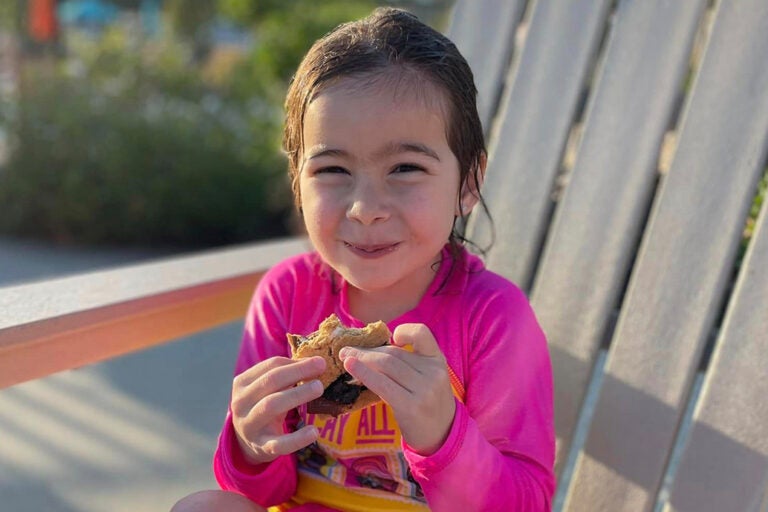 little girl eating s'mores