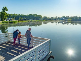Family fishing off dock at CreekFire RV Resort in Savannah, Georgia