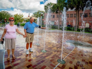 couple walking through splash pad in Winter Garden Florida