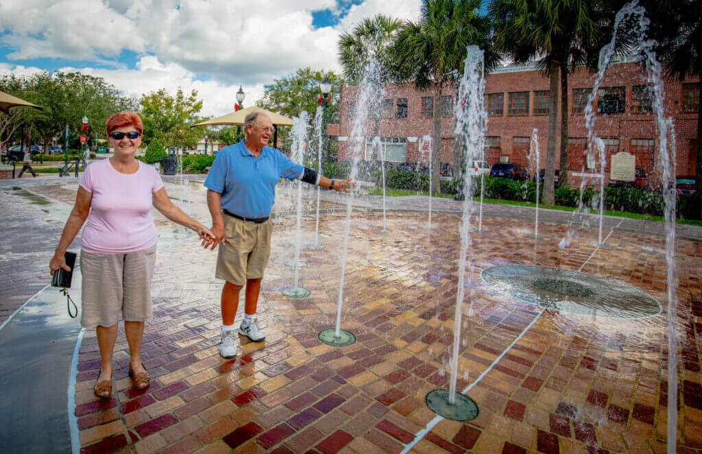 couple walking through splash pad in Winter Garden Florida