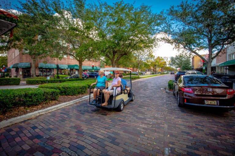 People in golf cart in winter haven