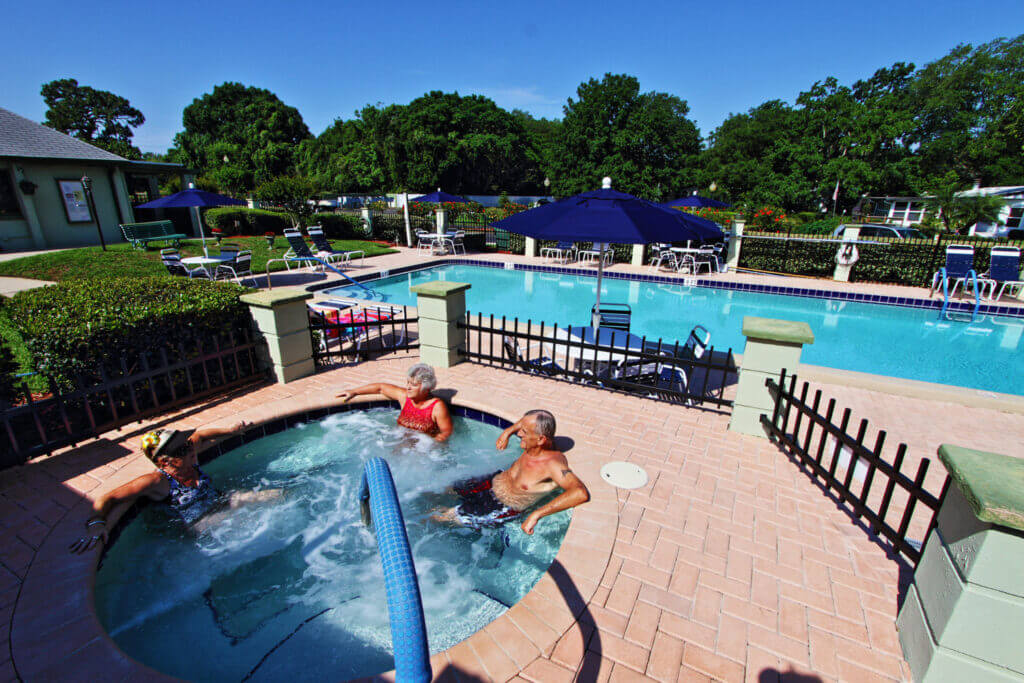 people in hot tub next to pool