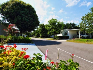 View of beautiful landscaping, flowers, and trees at the manufactured homes in Hyde Park Village