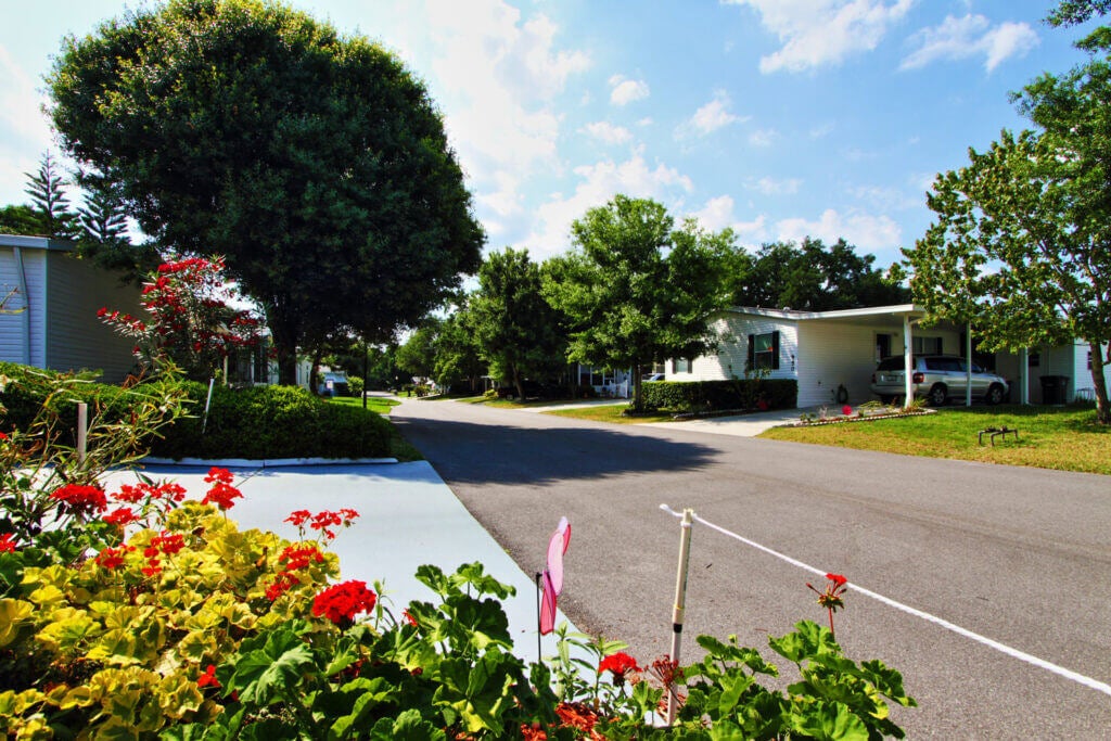 View of beautiful landscaping, flowers, and trees at the manufactured homes in Hyde Park Village