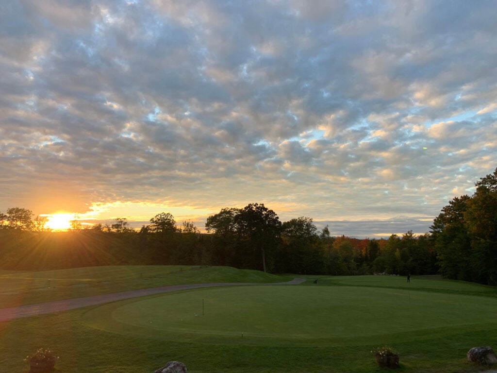 Sunset over golf course practice facility