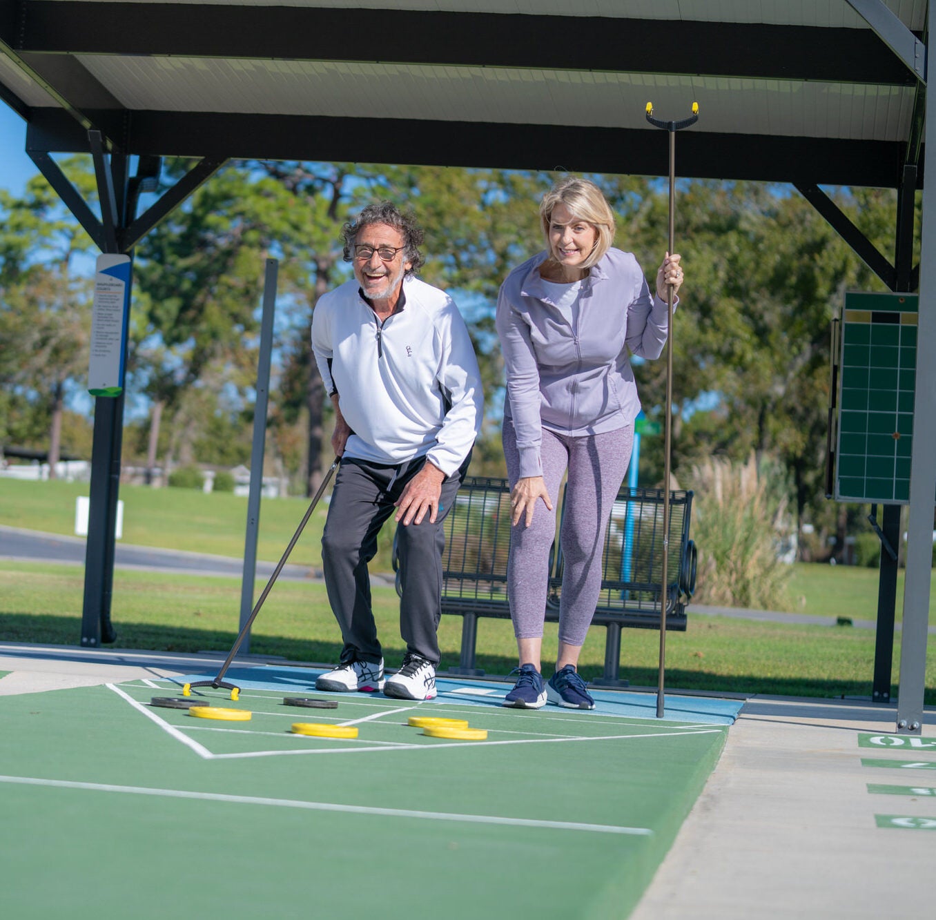 rolling greens village - couple playing shuffleboard