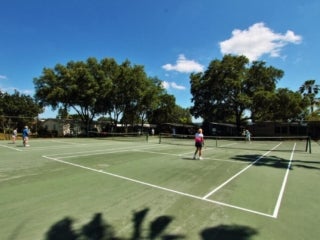 View of players playing on the tennis court at Strawberry Ridge Village.