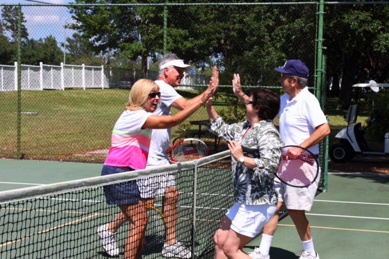 tennis players meeting at the net