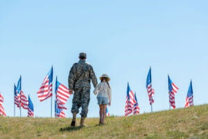 Veteran and child with flags