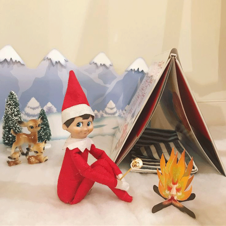 elf making s'mores in front of tent