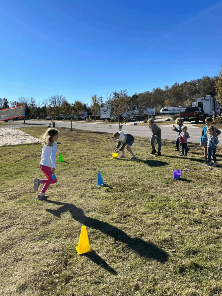 kids running between cones in relay race