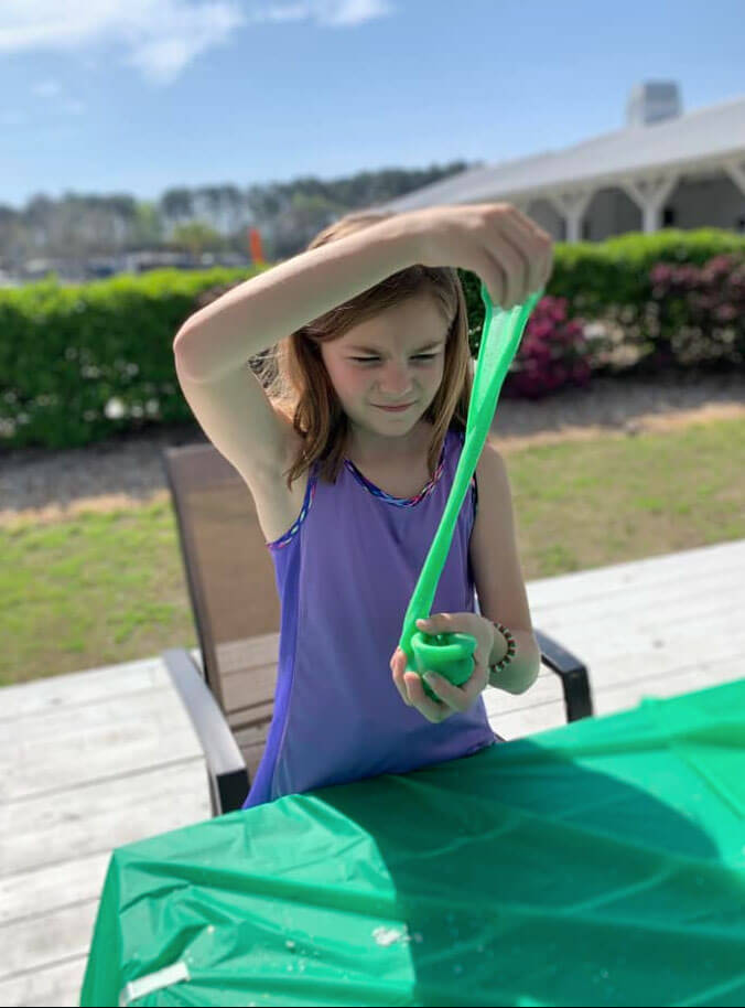 little girl stretching slime