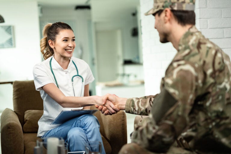 nurse shaking hands with soldier