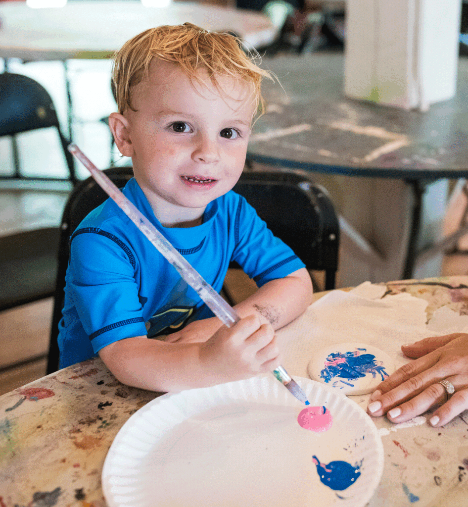 young kid painting coaster