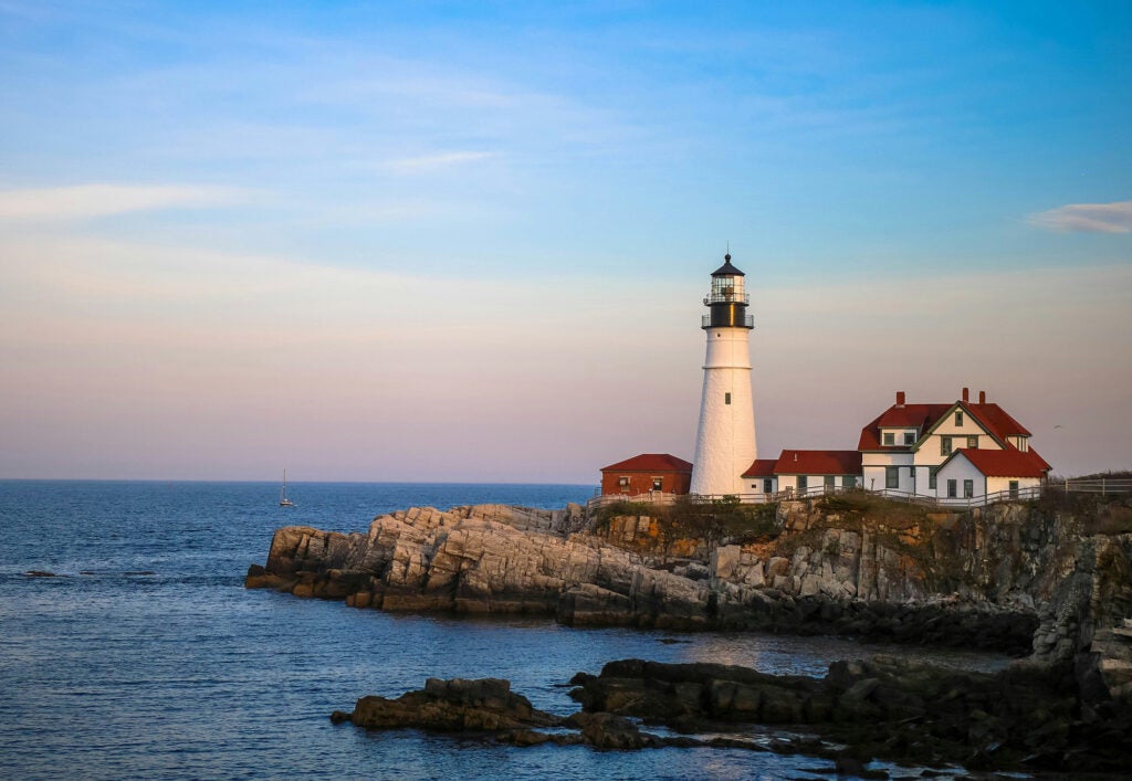 Maine Lighthouse on rocky shore new Point Sebago Resort