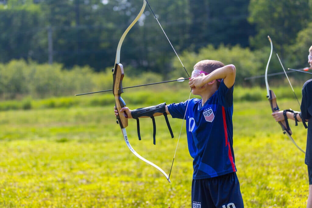 Point Sebago -activities-archery-072023-web-1 Point Sebago boy shooting bow and arrow