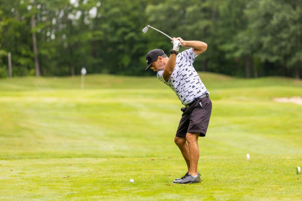 point sebago-golf-member-member-2023-full-7 Man hitting golf ball on tee box at Point Sebago Resort Golf Course in Casco, Maine.