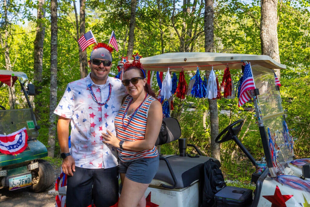 family next to decorated golf cart