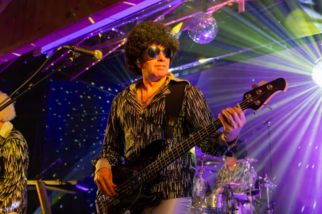Motor Booty Affair guitar player on stage with 70s costume
