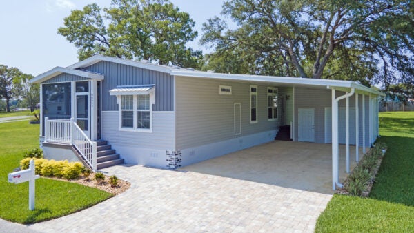 New 2024 blue-grey two-tone home at RGV with a screened in porch