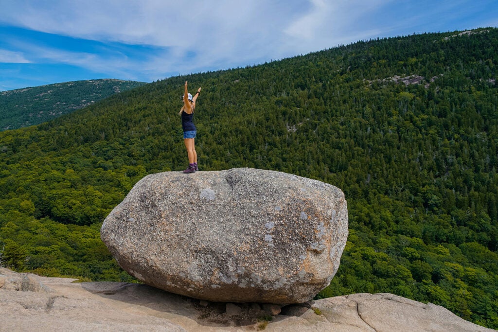 Maine hiker on top of a boulder