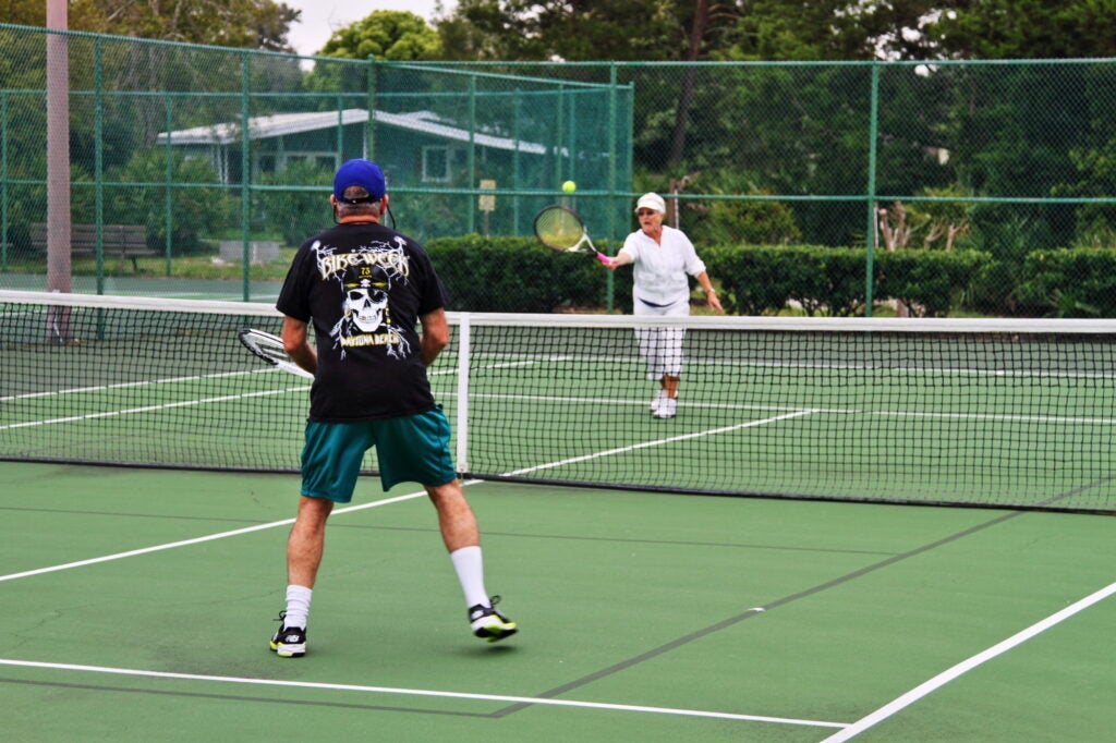 Residents Playing Tennis at Bear Creek Village