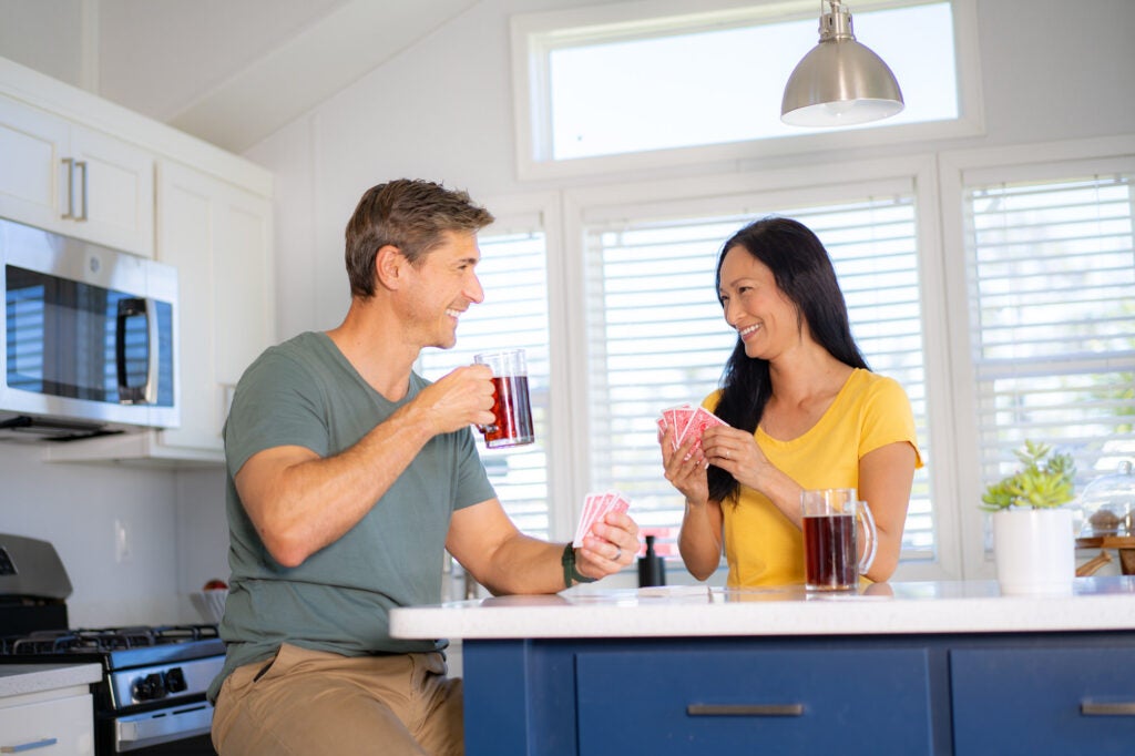 couple playing cards in cottage at river vista rv