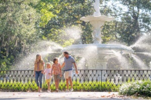 Family tours Forsyth Park in Savannah, Georgia during their visit to CreekFire RV Resort.