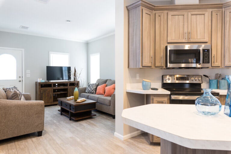 Kitchen and living room inside a manufactured home at The Meadows in Florida.