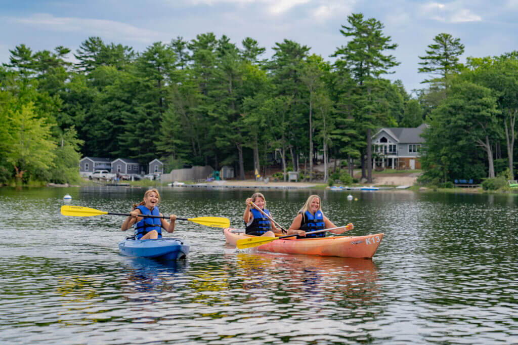women kayaking on Sebago Lake in Casco, Maine.