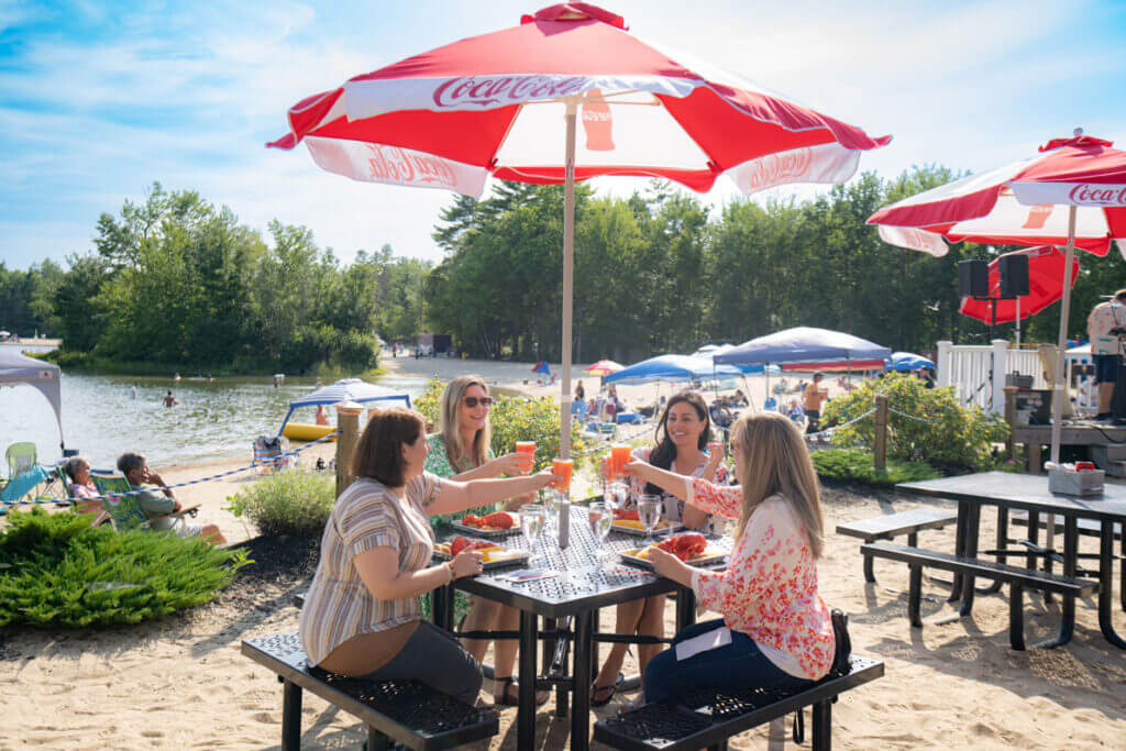 Point-Sebago_Lobster_Dinner Women eating a lobster dinner at Point Sebago Resort in Maine.