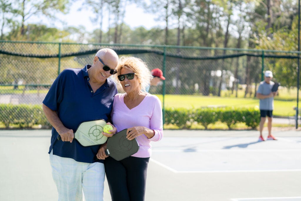 Couple leaving the pickleball court in a senior community in Florida.