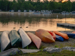 Canoes along Sebago Lake at Point Sebago Resort in Maine.