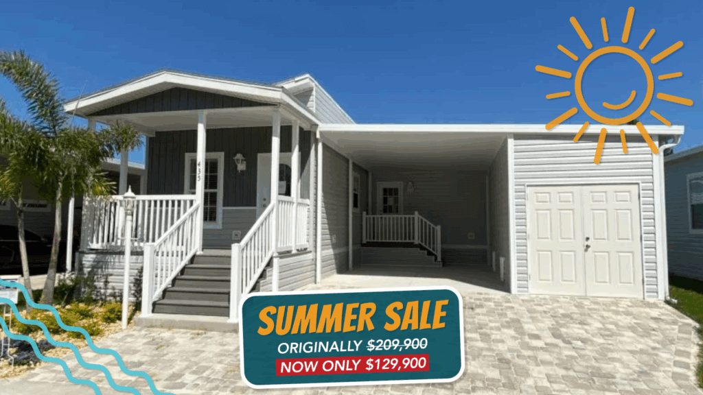 grey manufactured home with sticker that says Summer Sale