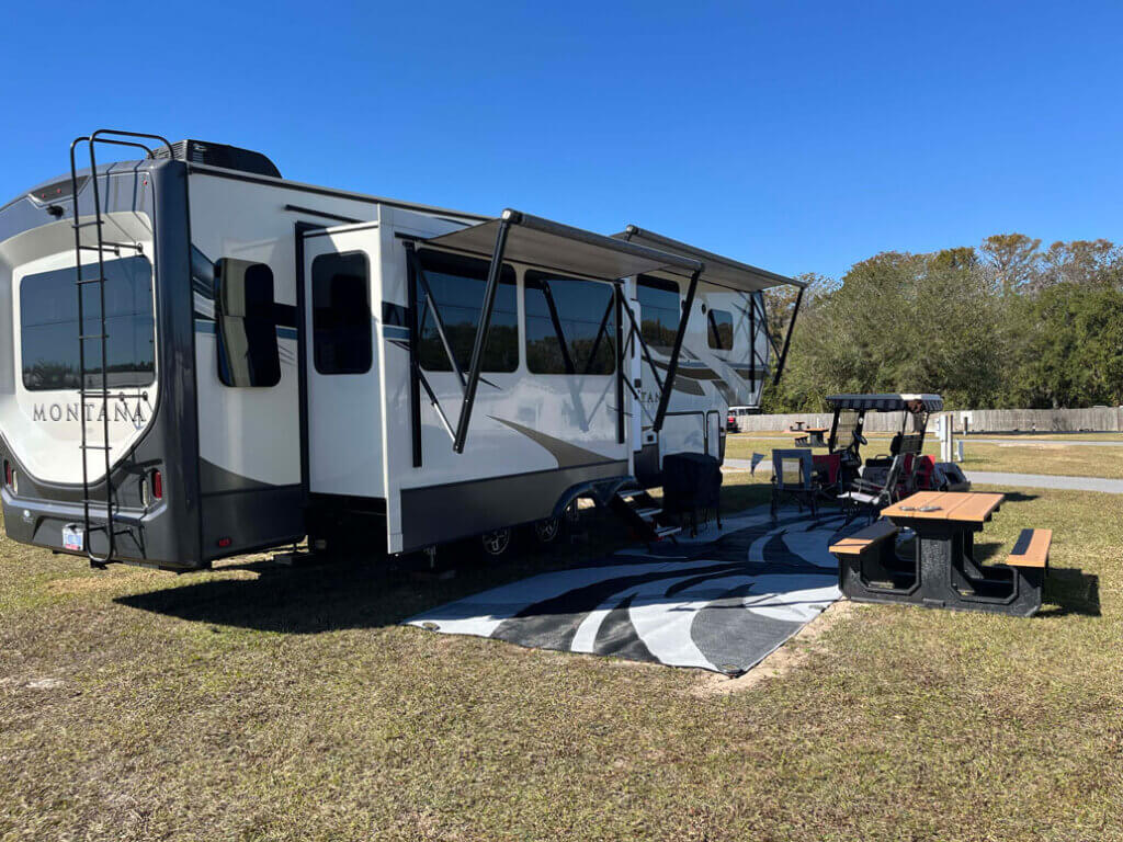 RV site, picnic table, and golf cart at Holiday RV Park in Florida.