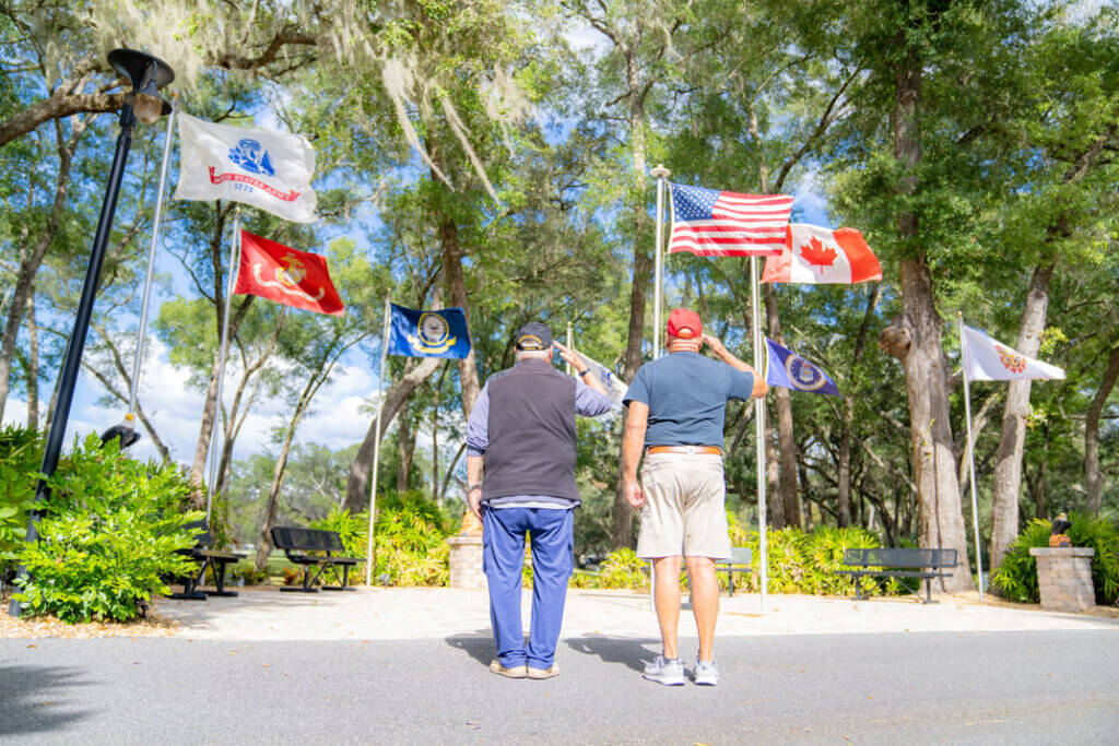 Veterans salute the American flag in Ocala, Florida at Rolling Greens Village, a 55+ retirement community.