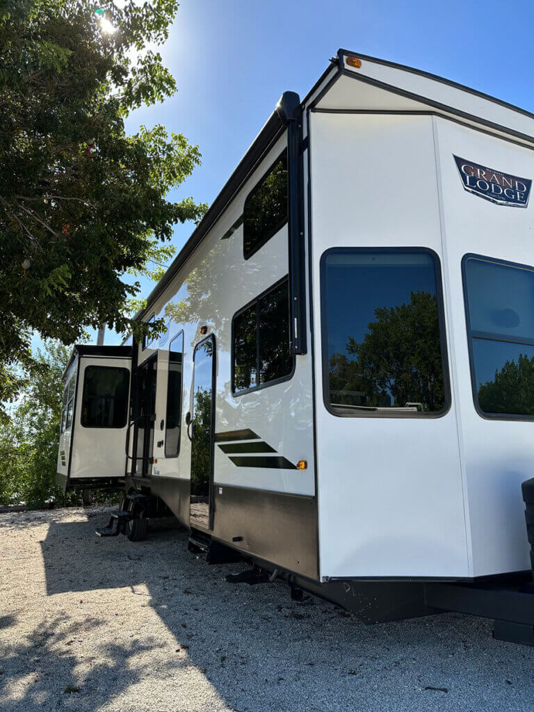 Exterior of the Wildwood Grand Lodge trailer by Forest River, available for rent along the waterfront at Big Pine Key RV Park in Florida.