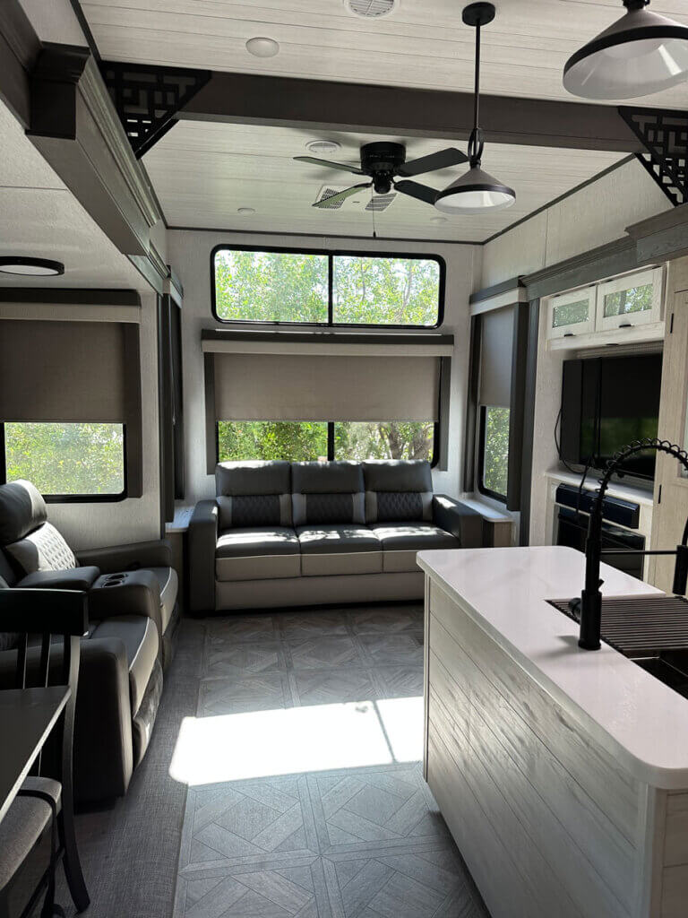 Living room in the Wildwood Grand Lodge trailer by Forest River, available for rent along the waterfront at Big Pine Key RV Park in Florida.