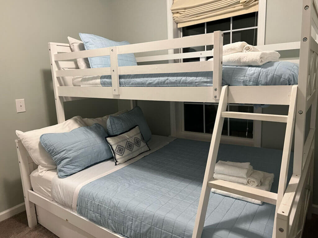 Bunkbeds in a Point Sebago double-decker cabin with linens and towels.