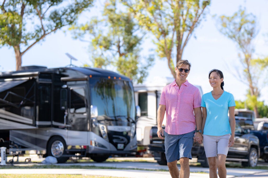 Couple walking past RV sites at River Vista RV Park in Ruskin, Florida.