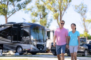 Couple walking past RV sites at River Vista RV Park in Ruskin, Florida.