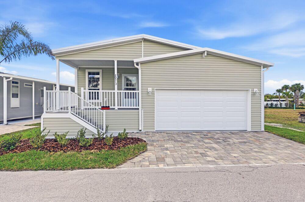 The exterior and porch of a manufactured home in Estero Bay Village, a 55+ community in Florida.