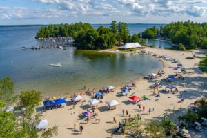 Tents lined up along the Maple Cove Beach along the shores Sebago Lake of Point Sebago Resort in Maine.