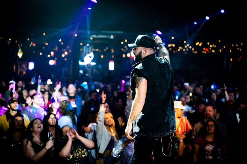 Blake Tyler singing at a country music concert.