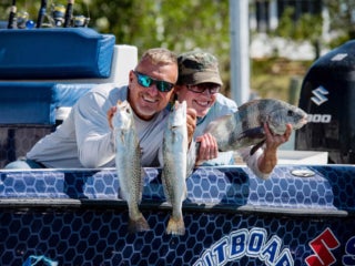 Couple shows off their three fish at Chokoloskee RV Park in Florida.