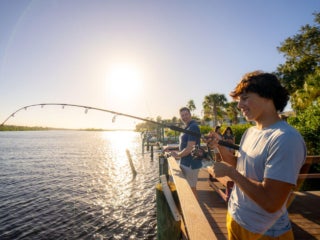 Teenage boy fishing off the shore of the Little Manatee River at River Vista RV Park.