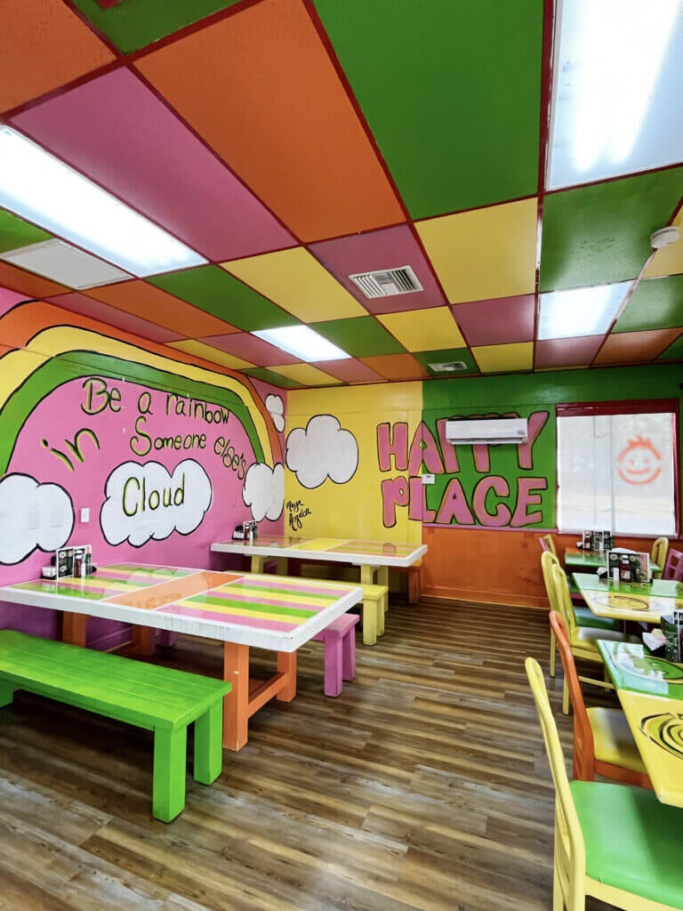 Painting on the Interior walls of FK Your Diet say "Happy Place" and "Be a rainbow in someone else's cloud".