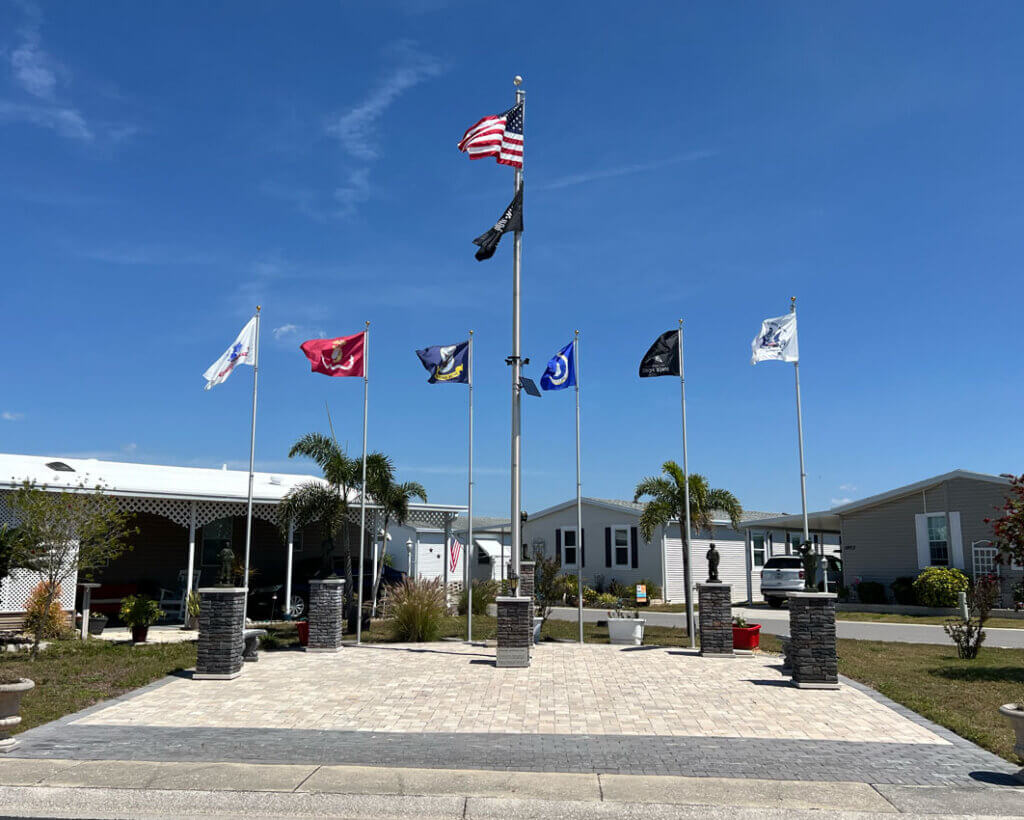 Flag poles flying the United State military flags in the repaired Veterans Plaza at The Meadows in Tarpon Springs, Florida.